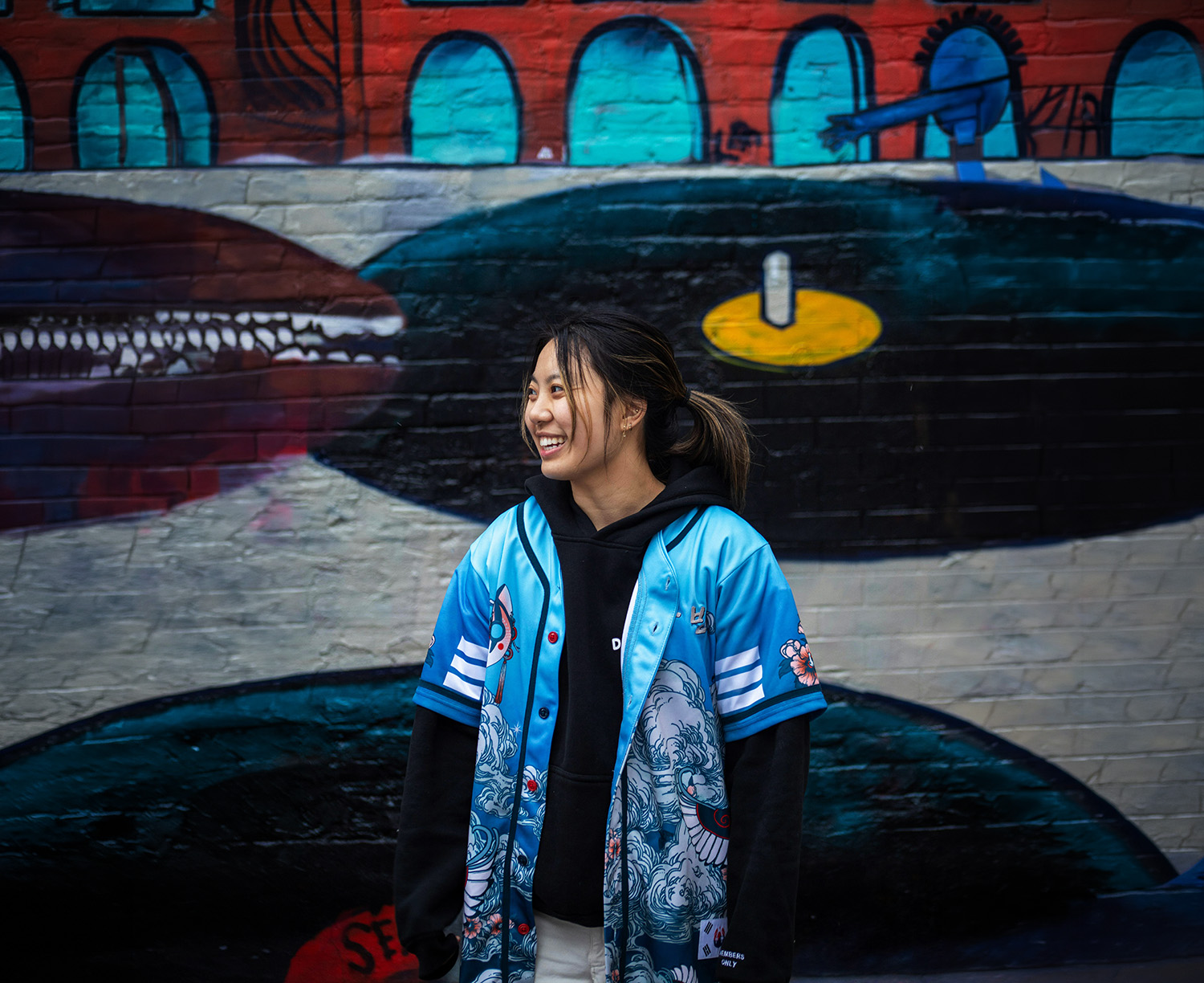 Page 19 Photograph of a young woman wearing a blue jersey. She looks off-camera with a joyful, relieved expression. The image reflects the resolution of a client’s communication needs.