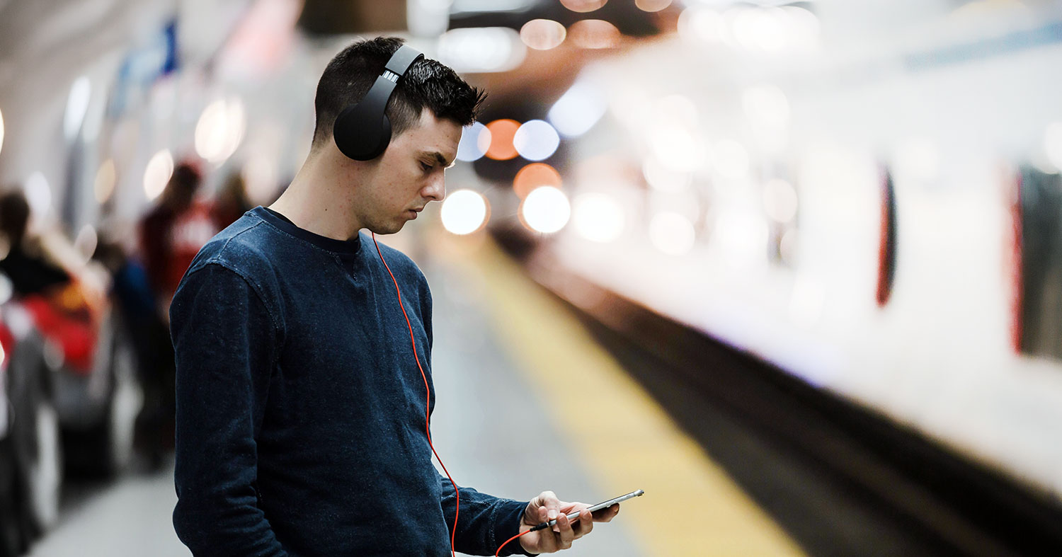 Young person standing on a subway platform