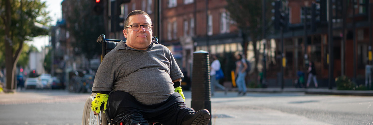 Man in a wheelchair commuting downtown.